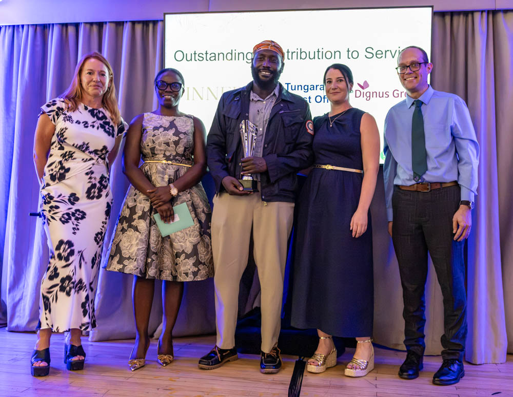 Nicolai Tungaraza from The Old Post Office receiving the Outstanding Contribution to Service Award